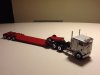 Freightliner with step deck trailer silver red
